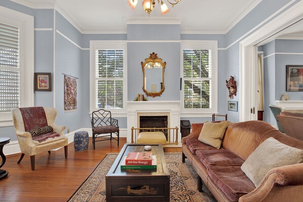 A living room with a fireplace, a sofa, a coffee table, and a chair.