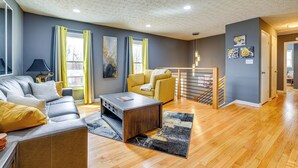 A modern living room with a sofa, coffee table, and yellow armchair.