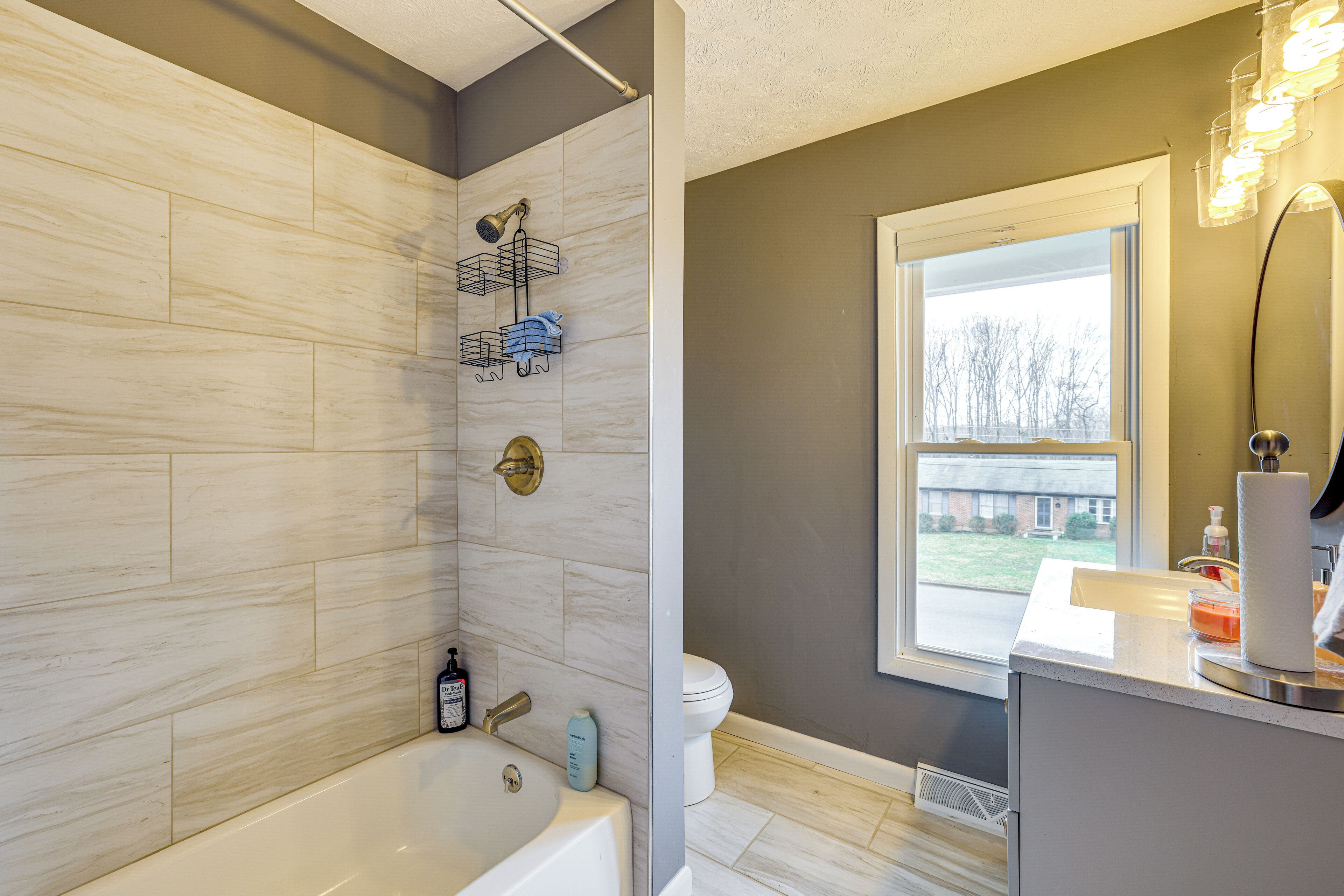 Une salle de bain moderne équipée d’une baignoire, d’une douche et de toilettes.