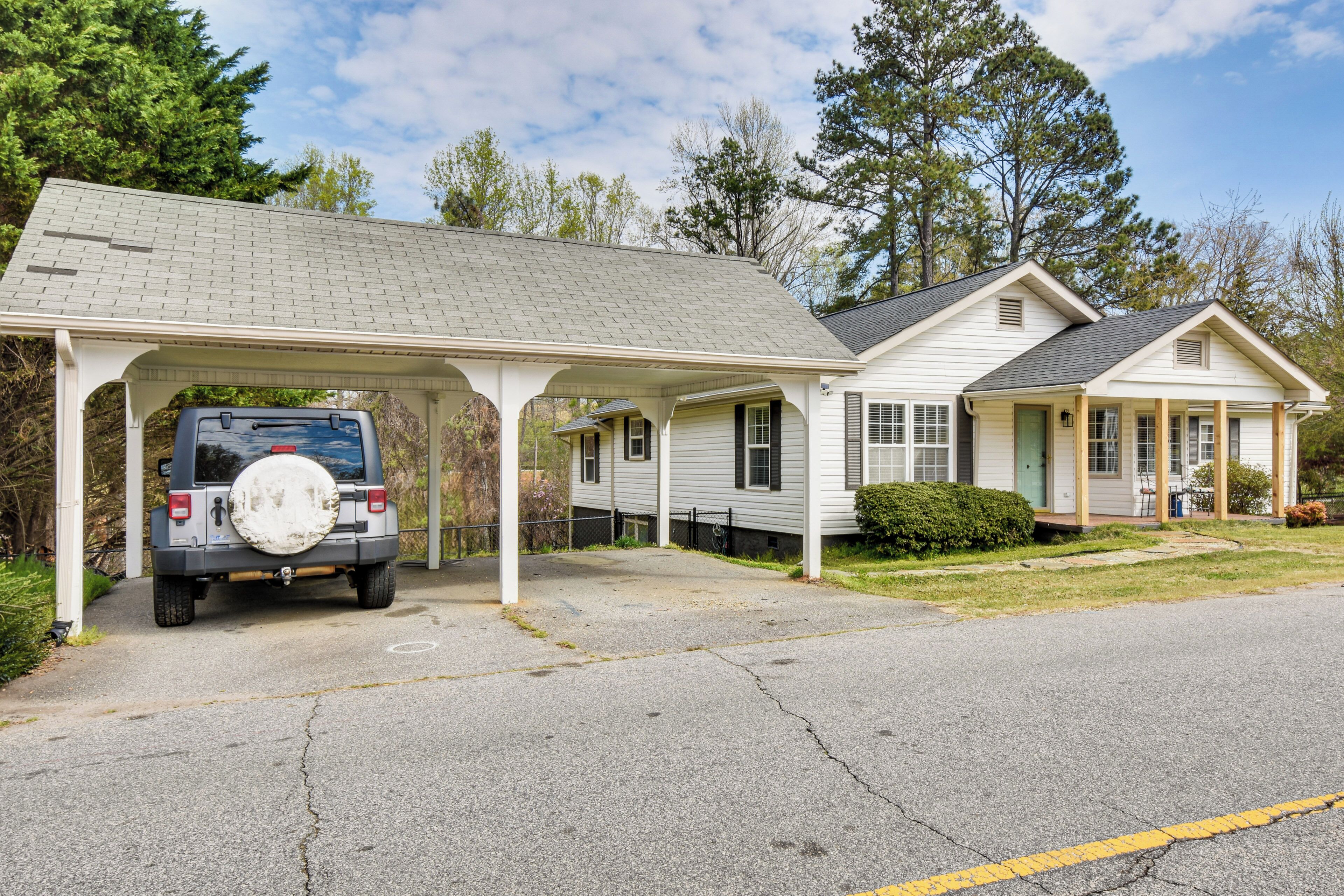 A two-story house with a covered garage and a driveway.