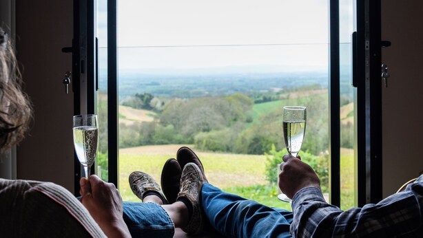 Two people sitting by a window with a view of a green landscape. - Hanley House (Tenbury Wells)