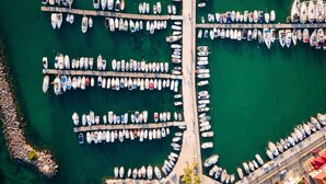 An aerial view of a marina with multiple docks and boats. - Aegina Dream Suites (Aegina)