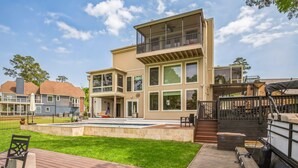 A modern two-story house with a large deck, a swimming pool, and a boat dock. - Lakefront Retreat With Private Pool, Hot Tub And Dock 4 Bedroom Home (Montgomery)