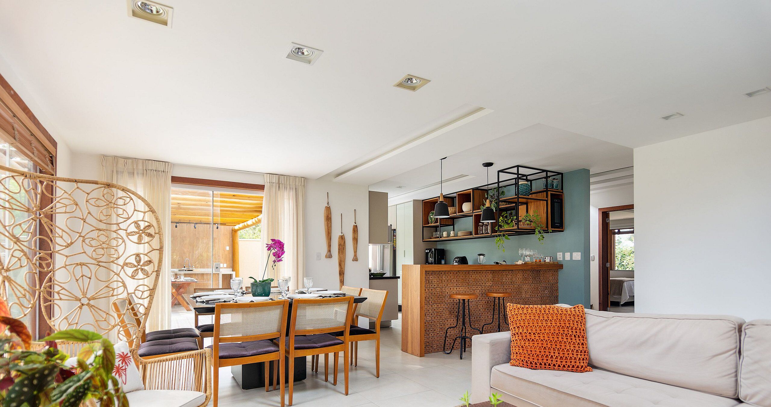 A modern living room with a dining area, kitchen, and a cozy seating area.