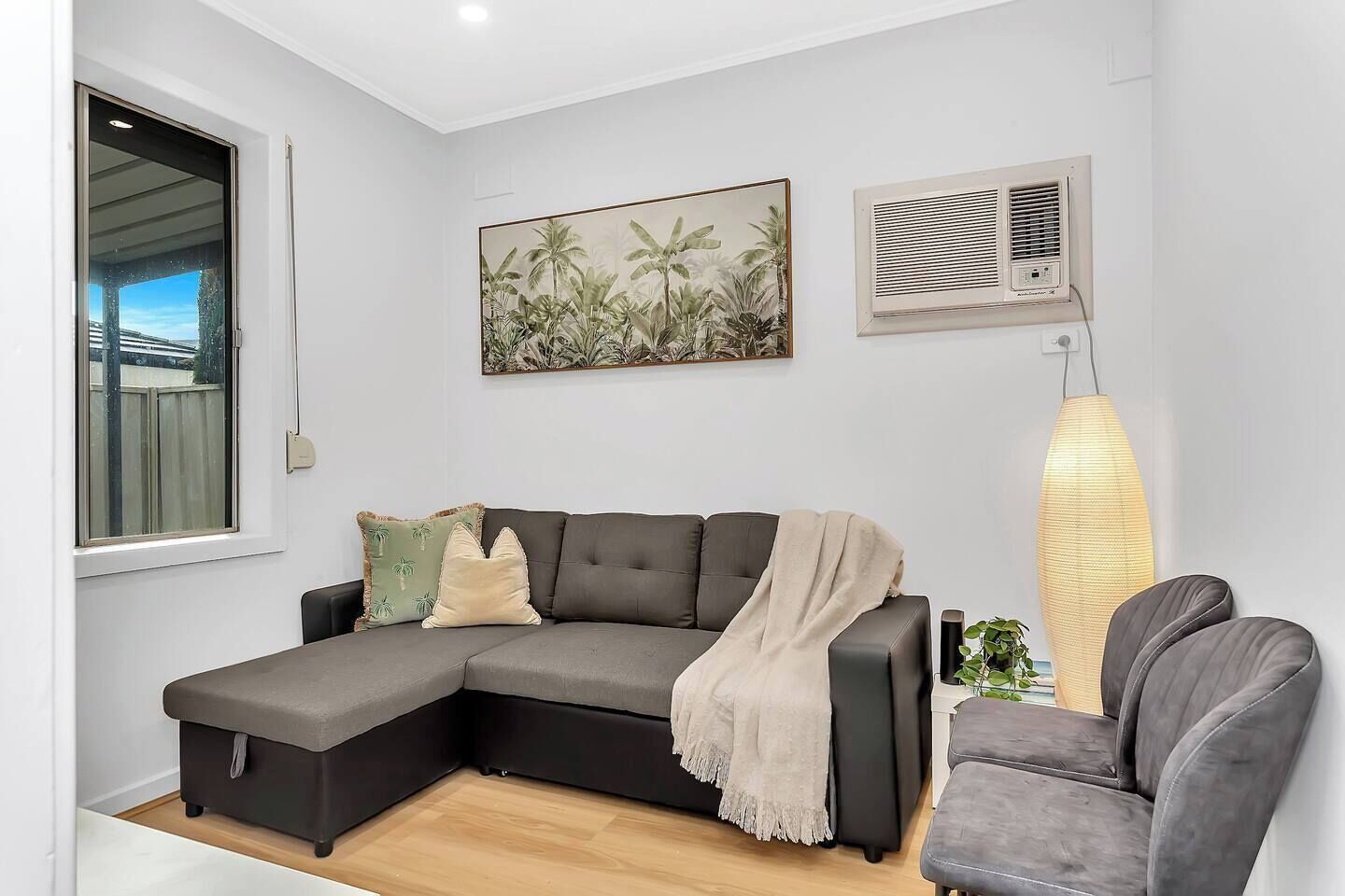 Settle into the cosy living room after a day of shopping or sightseeing—perfect for movie nights, quiet reading, or simply cooling off with split system air conditioning.
