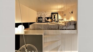 A modern bedroom with a bed, wall-mounted artwork, and pendant lighting. - Cracow Fancy Brick #3 – Old Town (Kraków)