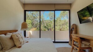 A bedroom with a large bed, a desk, and a TV. - Jungle Villa Oasis, large private pool & Starlink (Tulum)