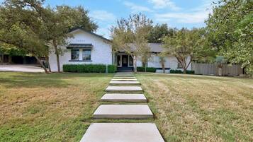 A house with a paved pathway leading to the front door.