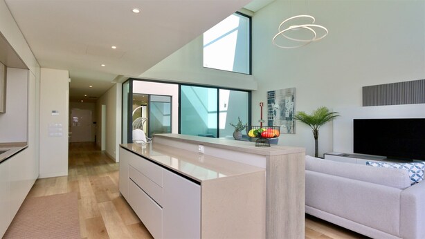 A modern kitchen with a white countertop, a built-in oven, and a window above the sink. - Villa Essence by Clever Details, private pool, walk distance to the marina (Quarteira)