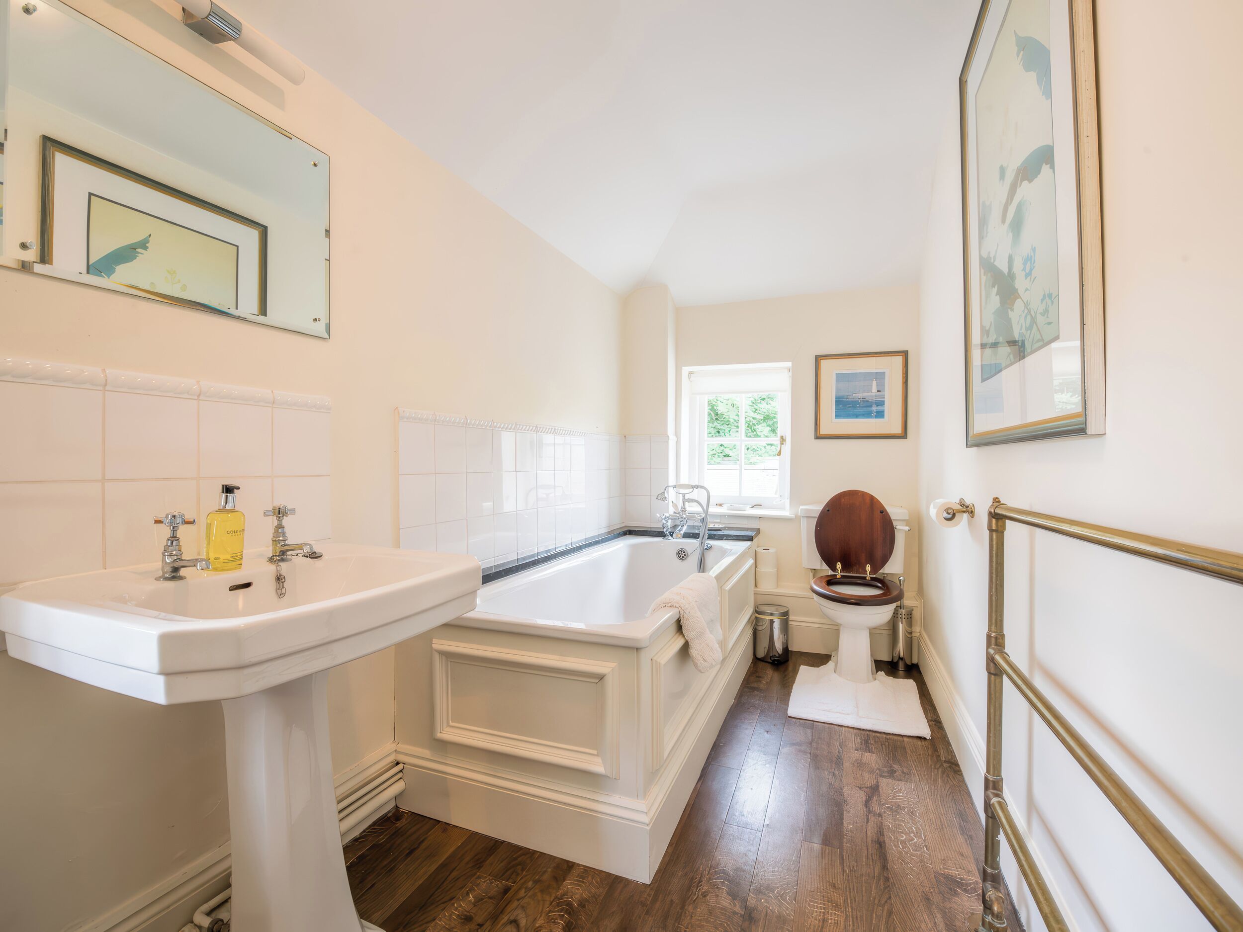 A bathroom with a white sink, a bathtub, and a toilet.