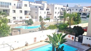 A rooftop swimming pool with a view of residential buildings and a clear sky. - Charming 3-bedroom Penthouse with AC, WiFi in lovely Oroklini (Oroklini)
