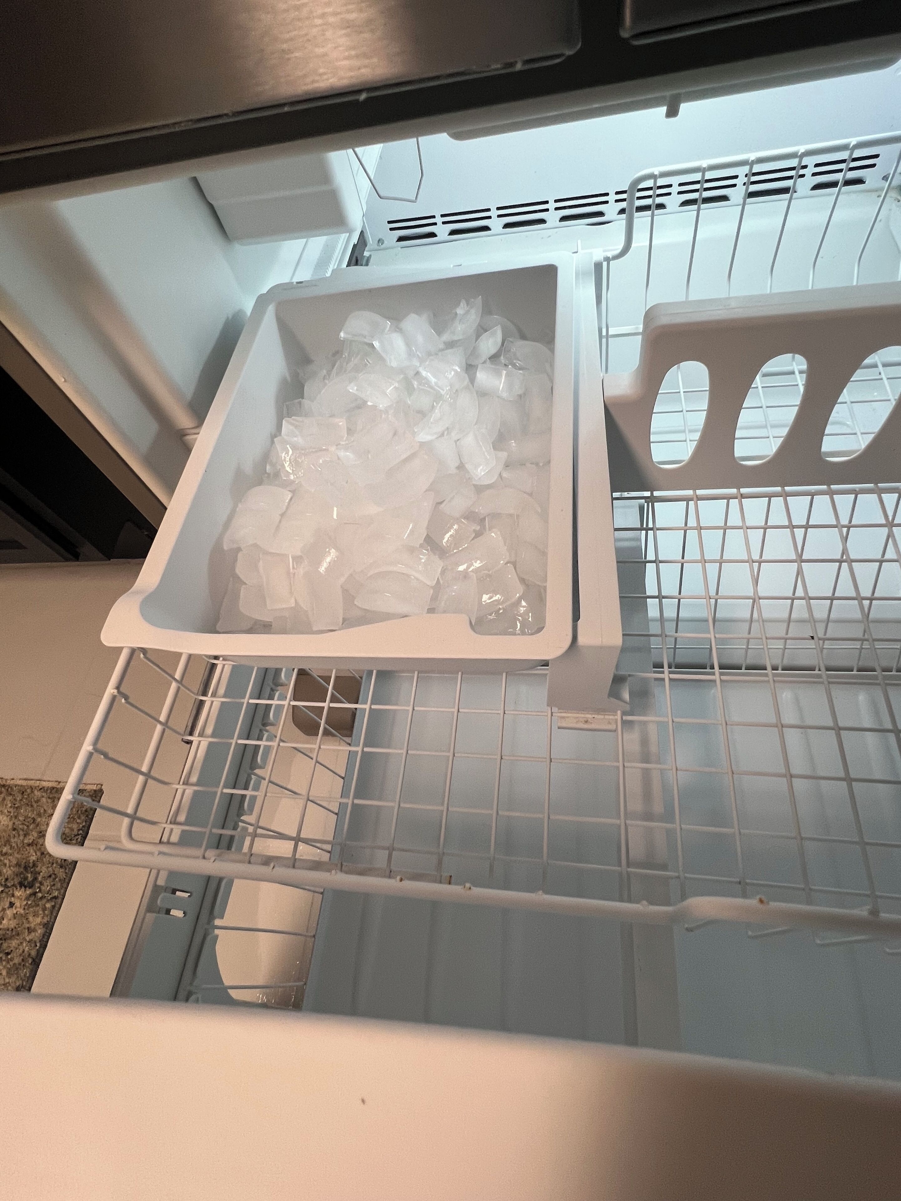 A kitchen with a white refrigerator, a sink, and a countertop.