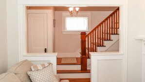 A staircase leading to a second floor, flanked by white walls and a wooden railing. - Dutch Retreat • Near Lakes • Walk Town (Bridgton)