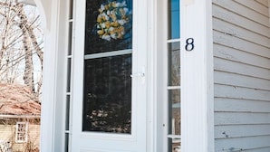 A white front door with a glass panel and a number '8' on the wall. - Dutch Retreat • Near Lakes • Walk Town (Bridgton)
