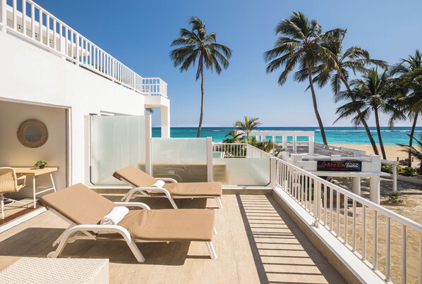 A balcony with sun loungers, a pool table, and a sign for 'La Mesa Inn'.