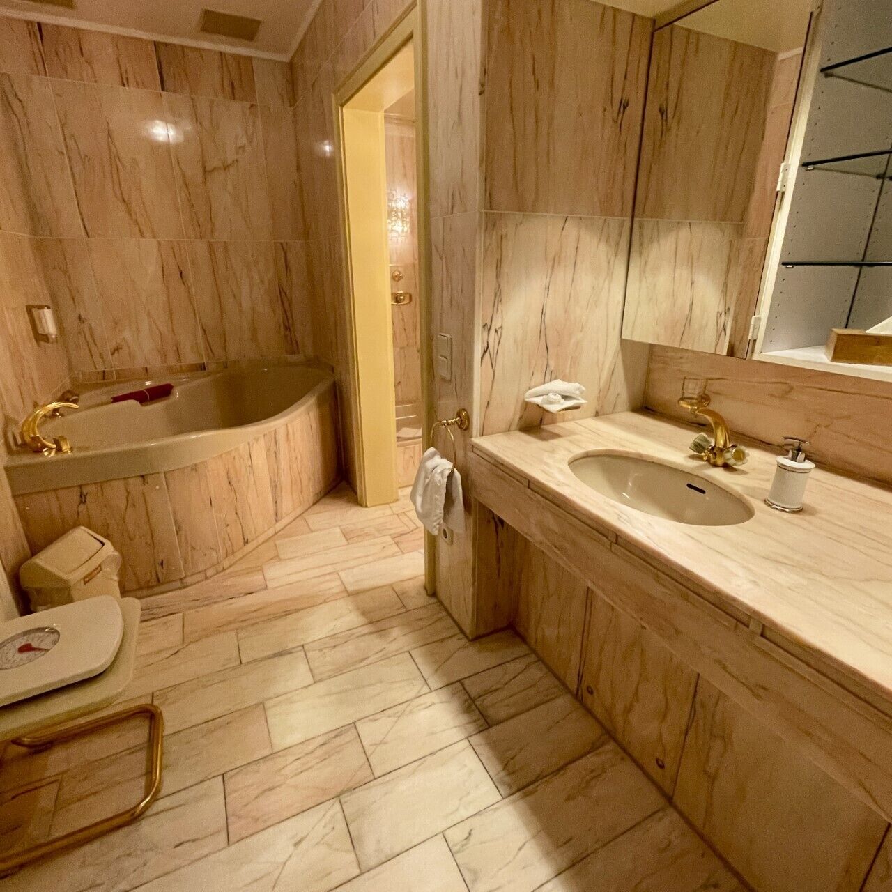 A bathroom with a freestanding bathtub, a sink, and a mirror.