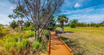 Palm-lined home with dock access, firepit & inviting balconies