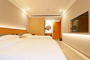 A hotel room with a large bed, a bedside table, a mirror, and a door leading to a bathroom. - Eisen Concept Hotel Shanghai (Jiangsu Road Subway Station) (Shanghai)