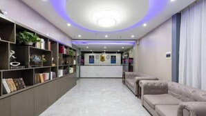 A modern reception area with a marble floor, a reception desk, and a seating area with sofas. - Super 8 (Beijing West Gongyi Bridge) (Beijing)