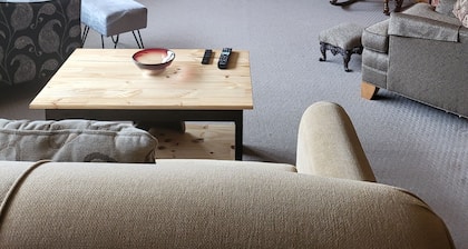 One bedroom and full bath in home 2 miles from EAA. Area with TV & refrigerator.