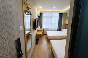 A hotel room with two beds, a desk, a chair, a television, and a mirror. - Hongxing Business Hotel (Shanghai)