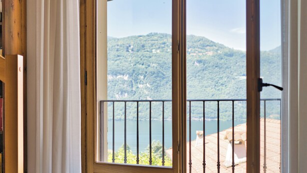 A wooden door with a view of a balcony overlooking a lake and hills. - La Dimora del Borgo - Two Bedroom House, Sleeps 6 (Lierna)
