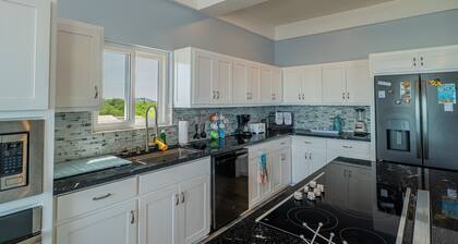 Ocean view retreat with a large balcony, luxe walk-in shower, kitchenette, & AC