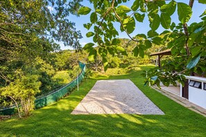 A well-maintained garden with a paved pathway leading to a building.