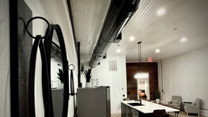 A modern kitchen with a central island, stainless steel appliances, and a large mirror. - “Downtown Boro Loft” Charming 1600 sq foot open concept Downtown Jacksboro (Jacksboro)