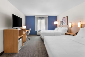 A hotel room with a TV, desk, chair, two beds, and a window with curtains. - Spark by Hilton Dothan (Dothan)