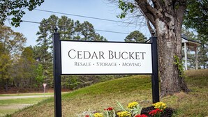 A sign for Cedar Bucket with services listed: resale, storage, and moving. - Cedar Bucket Lofts - Cozy 2-bedroom apartment in Oxford! (Oxford)