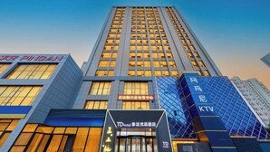A modern hotel building with a prominent entrance, large windows, and signage for TD Hotel and KTV. - Youpin Hotel (Linyi)