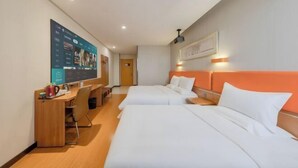 A hotel room with two beds, a desk, and a large screen displaying content. - Youpin Hotel (Linyi)