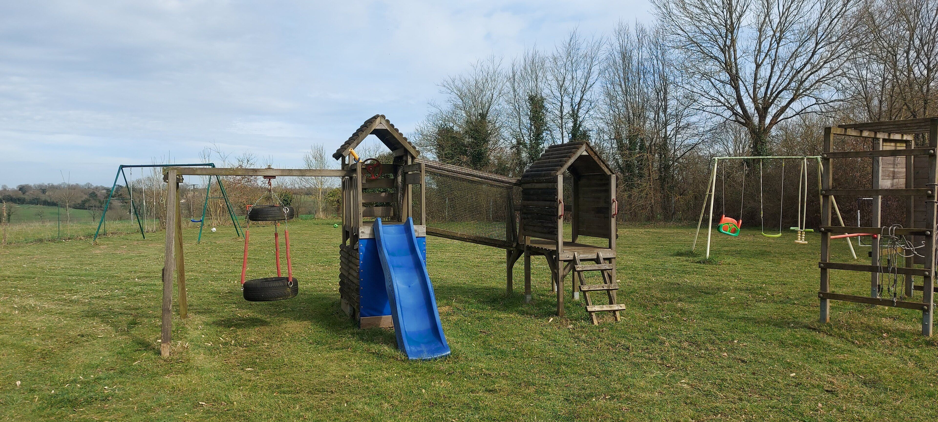 A playground with a slide, swings, and a climbing structure.