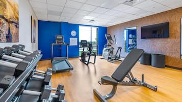 A gym with treadmills, a stationary bike, and a weight bench.