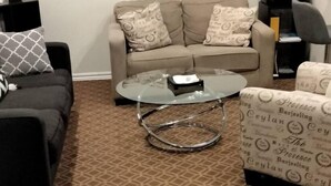 A living room with a sofa, a coffee table, and a framed picture on the wall. - Chic 1-bedroom apartment with AC, WiFi in fabulous West Hollywood (West Hollywood)