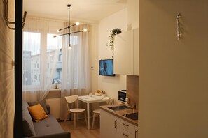Estudio Confort, 1 cama matrimonial y sofá cama, cocineta, vista al patio | Área de sala de estar