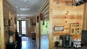 A wooden interior with a kitchen area, bar stools, and a sign reading 'Home to Lost.' - Cozy 2 bedroom cottage with heated pool AC in charming New Hope (New Hope)