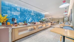 A modern hotel lobby with a blue-tiled wall, a reception desk, and seating areas. - Homeinn · neo (Haikou Qilou Old Street Donghu Road) (Haikou)