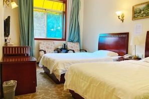 A hotel room with two beds, a desk, a chair, a trash bin, and a window with curtains. - Kehuayuan Hotel (Chengdu Huaxie) (Chengdu)