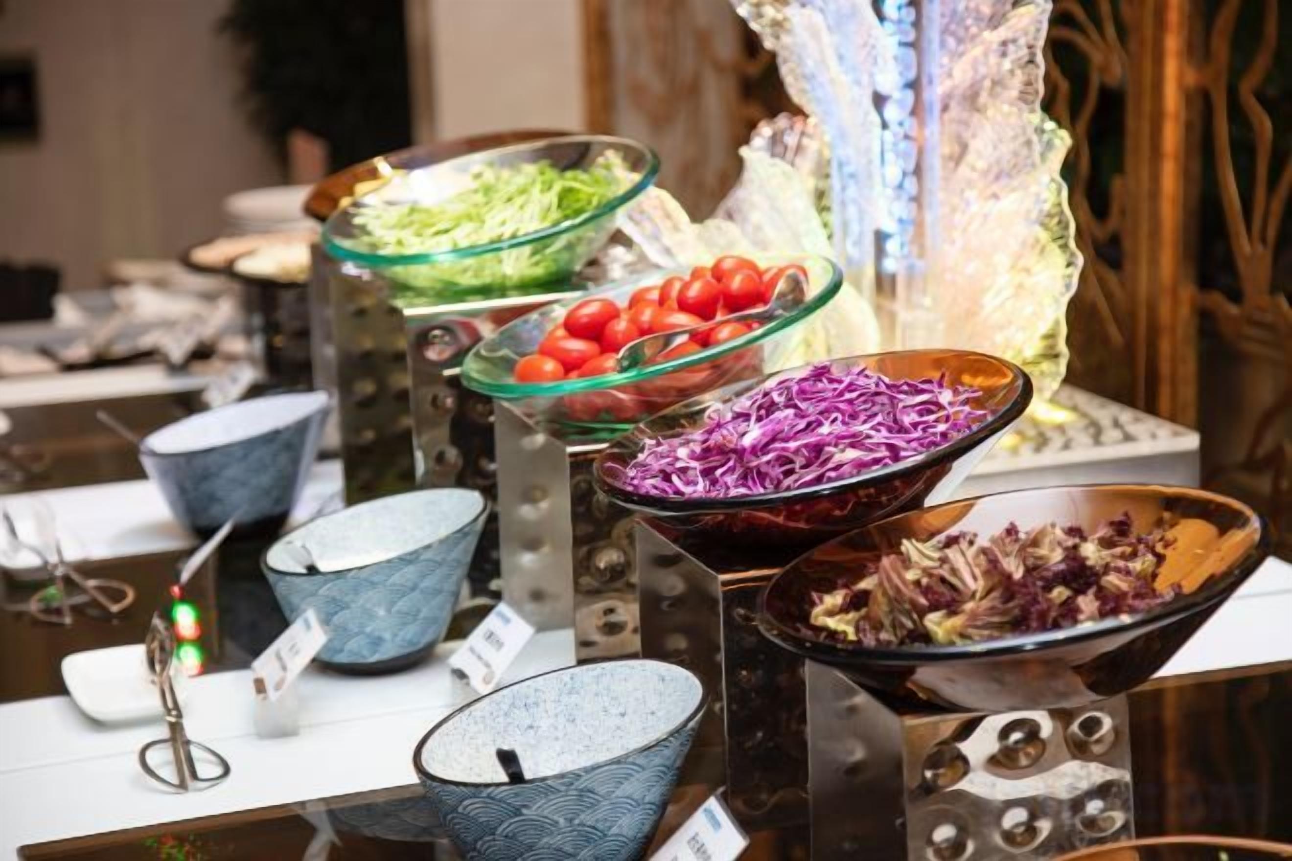 A variety of bowls with different colored contents, likely for food service.