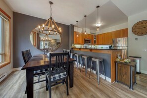 A modern kitchen with wooden cabinets, stainless steel appliances, and a central island. - Creeklight Chalet Panorama BC, 2 bed 2 bath, Prime location, Sleeps 7, Pet 🐾 (Panorama)