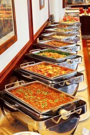 A buffet line with various dishes in trays. - Shangri-la Boutique Hotel (Wujie)
