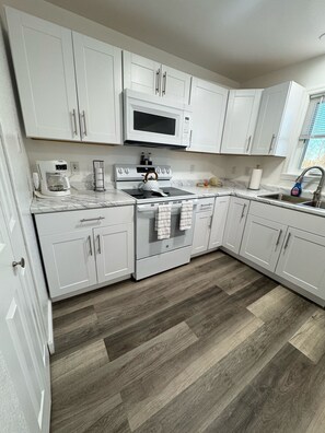 Fridge, microwave, stovetop, coffee/tea maker