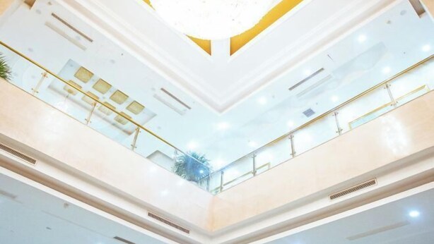 A multi-level atrium with glass railings and a central skylight. - Vienna Hotels Zao Zhuang QingTAN Road (Zaozhuang)