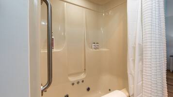 Un baño moderno con cabina de ducha, puerta de cristal y un perchero para toallas.
