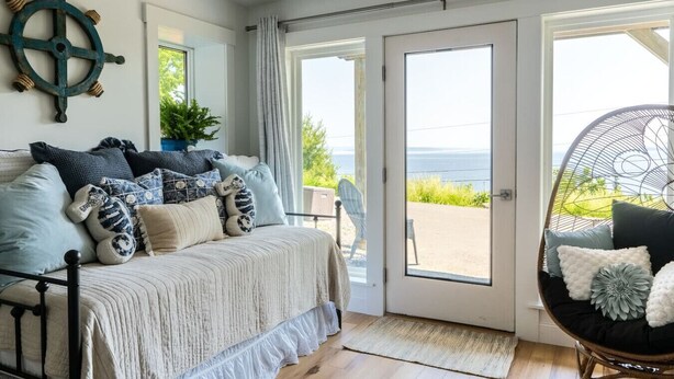 A cozy bedroom with a bed, a large window, and a view of the outdoors. - Lone Star Lodge - Newly Renovated Studio (Northport)