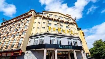 Un hotel de varios pisos con una entrada destacada y señalización.
