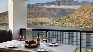A table set for dining with a scenic mountain view in the background. - The Bunker Charlie C (Queenstown)