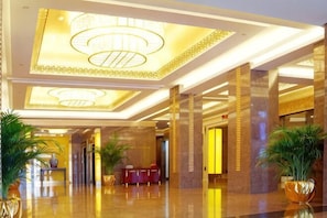 A hotel lobby with a high ceiling, chandeliers, and potted plants. - Chongwenmen Hotel（Near metro,Tian’anmen Square,Forbidden city And Temple of heaven） (Beijing)